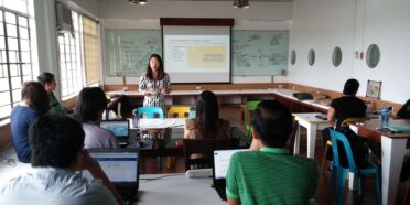 Woman presenting data to staff