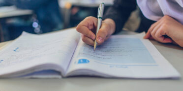 Student at Saffa Girls School writing in notebook